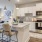 Model kitchen at Annabelle on Main apartments in Duluth, GA, featuring wood grain flooring and stainless steel appliances.
