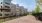 a row of buildings beside a gravel area