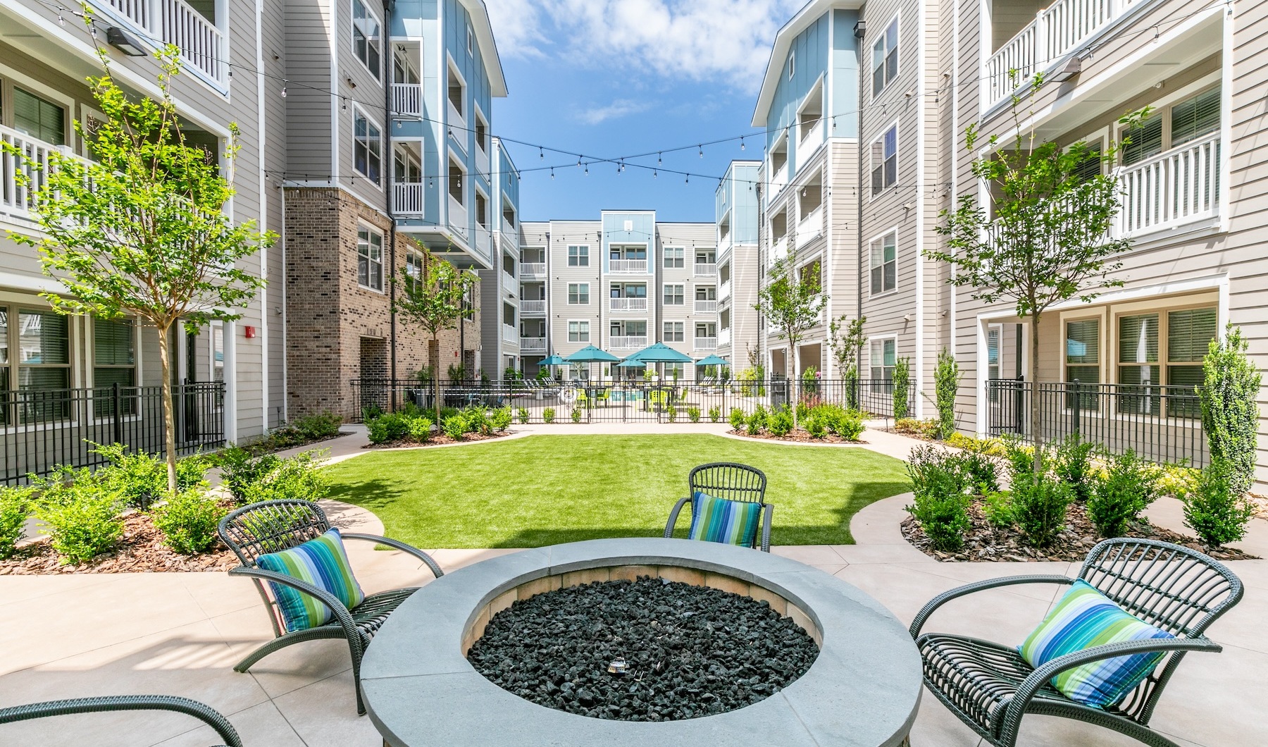 outdoor lounge area with seating and green turf