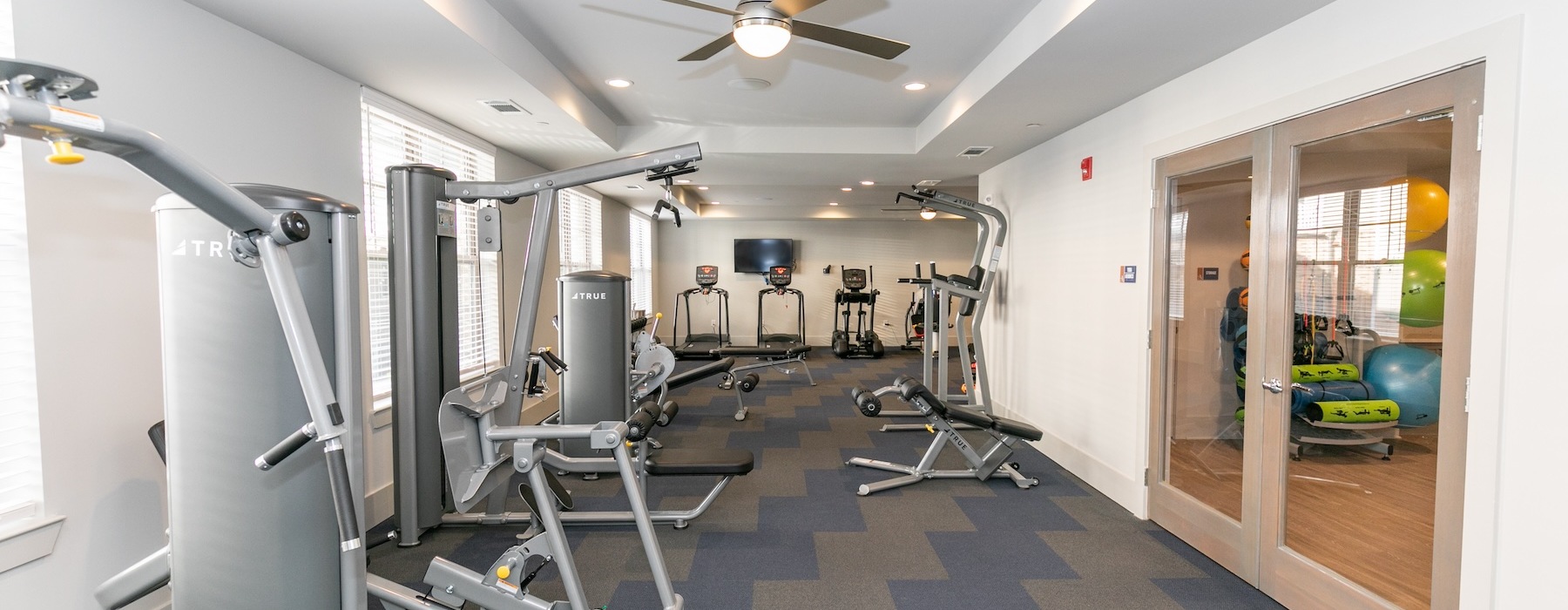 a room with treadmills and bright lighting