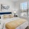 Bedroom at Annabelle on Main apartments in Duluth, GA, featuring carpeted floors, and bedside table, and a window.