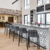 a kitchen with a bar and chairs