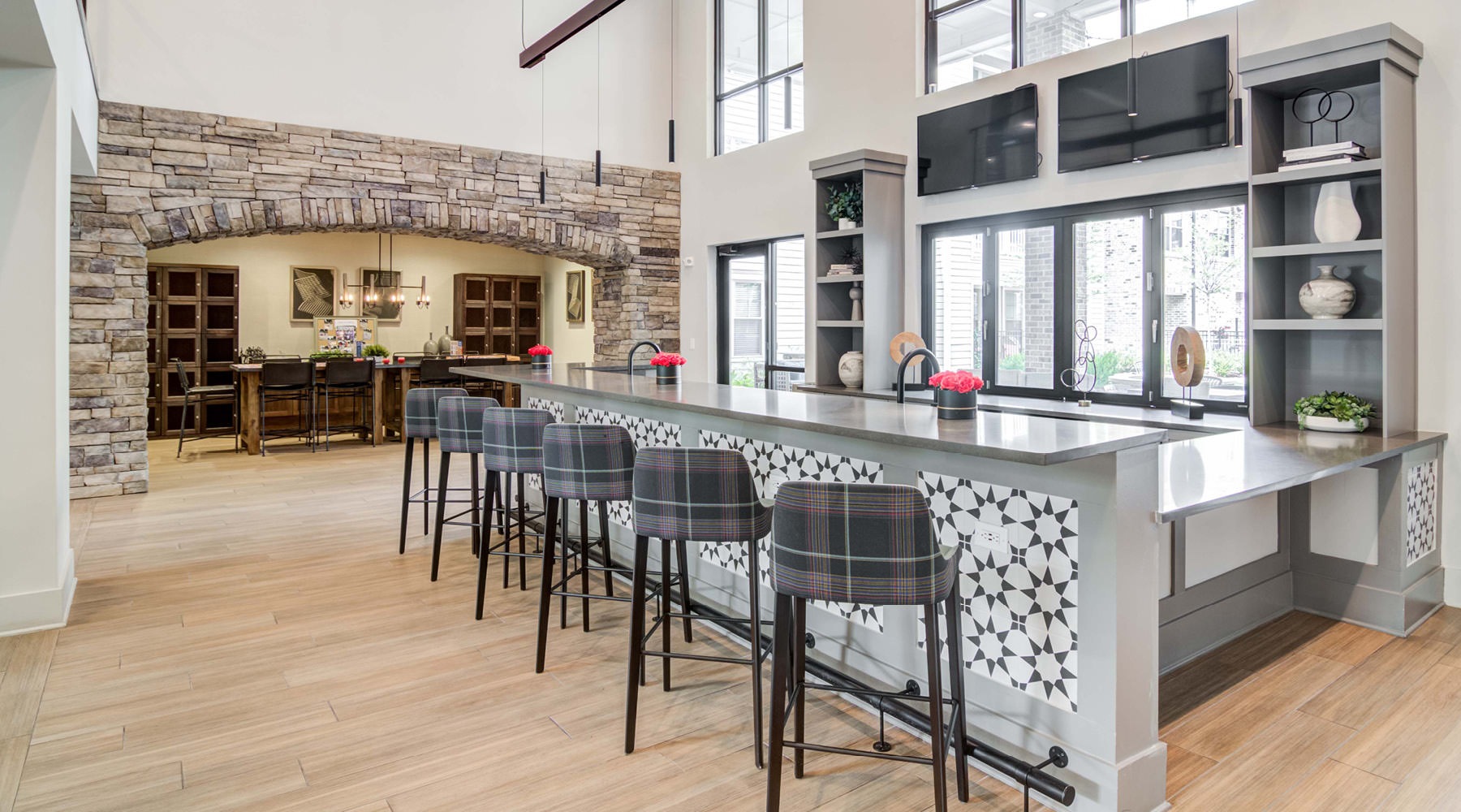 Resident lounge at Annabelle on Main apartments in Duluth, GA, featuring wood grain flooring and countertop seating.