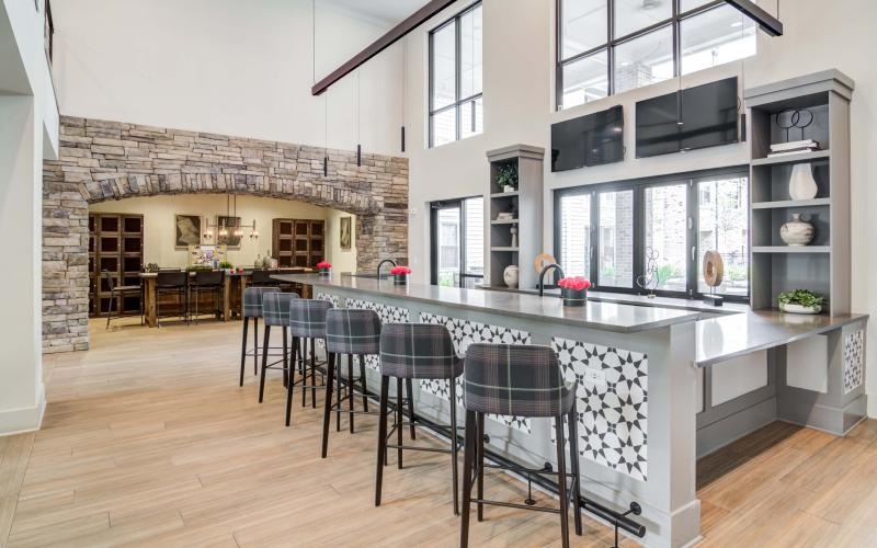 a kitchen with a bar and chairs